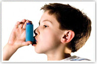 A young boy uses an inhaler. Image taken from the Take Action On Asthma leaflet.