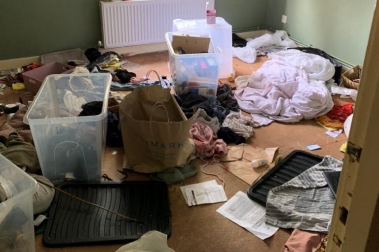 Image of messy bedroom full of junk from a property now in the possession of the Council following court action