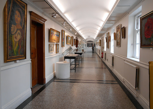 Corridor with paintings on the walls.