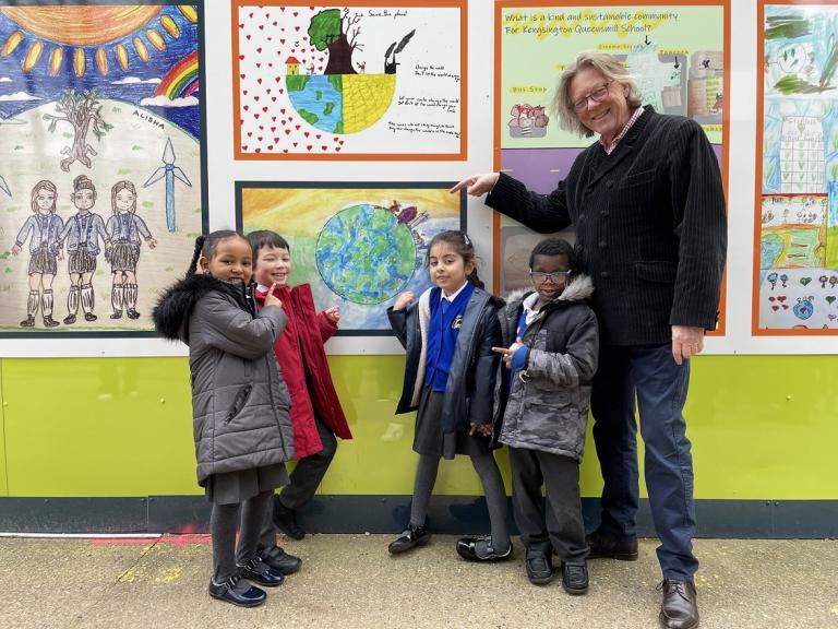 Pupils show off their artwork outside New Homes site